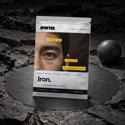 Spotter Iron wrinkle patch pouch standing on dark stone next to a black sphere