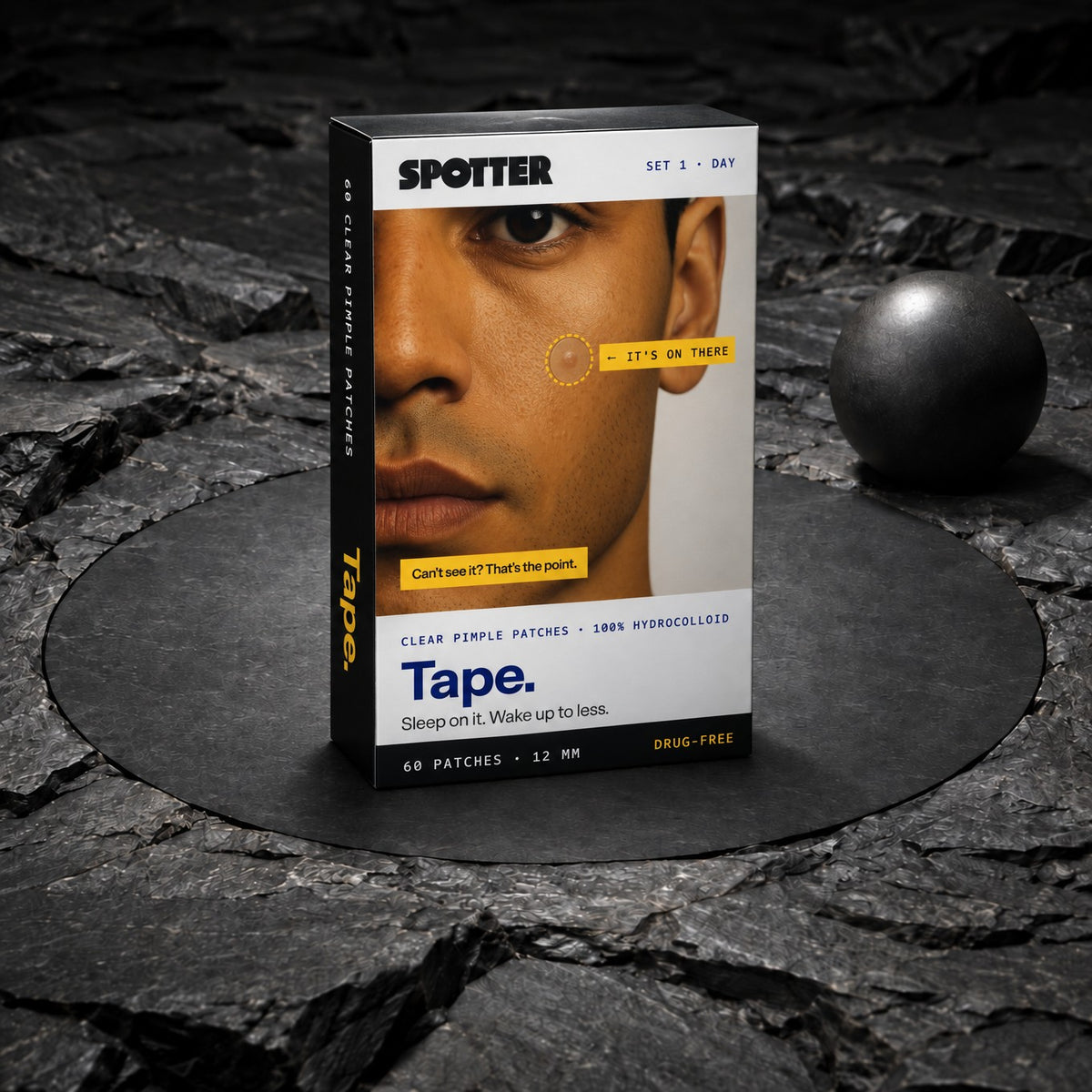 Spotter Tape pimple patch box standing on dark stone next to a black sphere