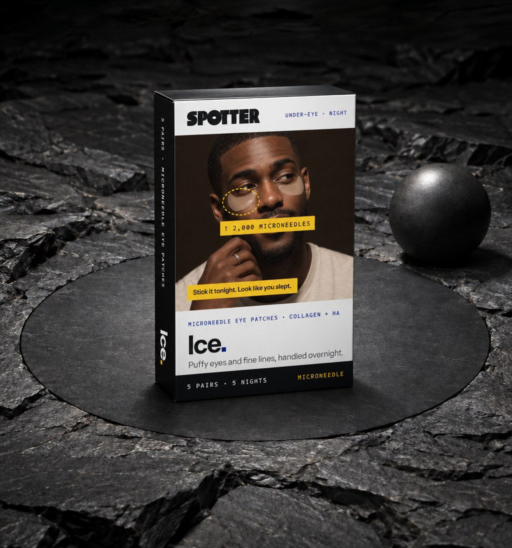 Spotter Ice microneedle eye patch box on dark stone next to a black sphere